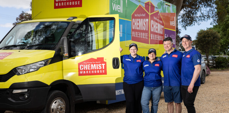 Four team members standing with a Chemist Warehouse vehicle as part of Daniher's Drive 2026.